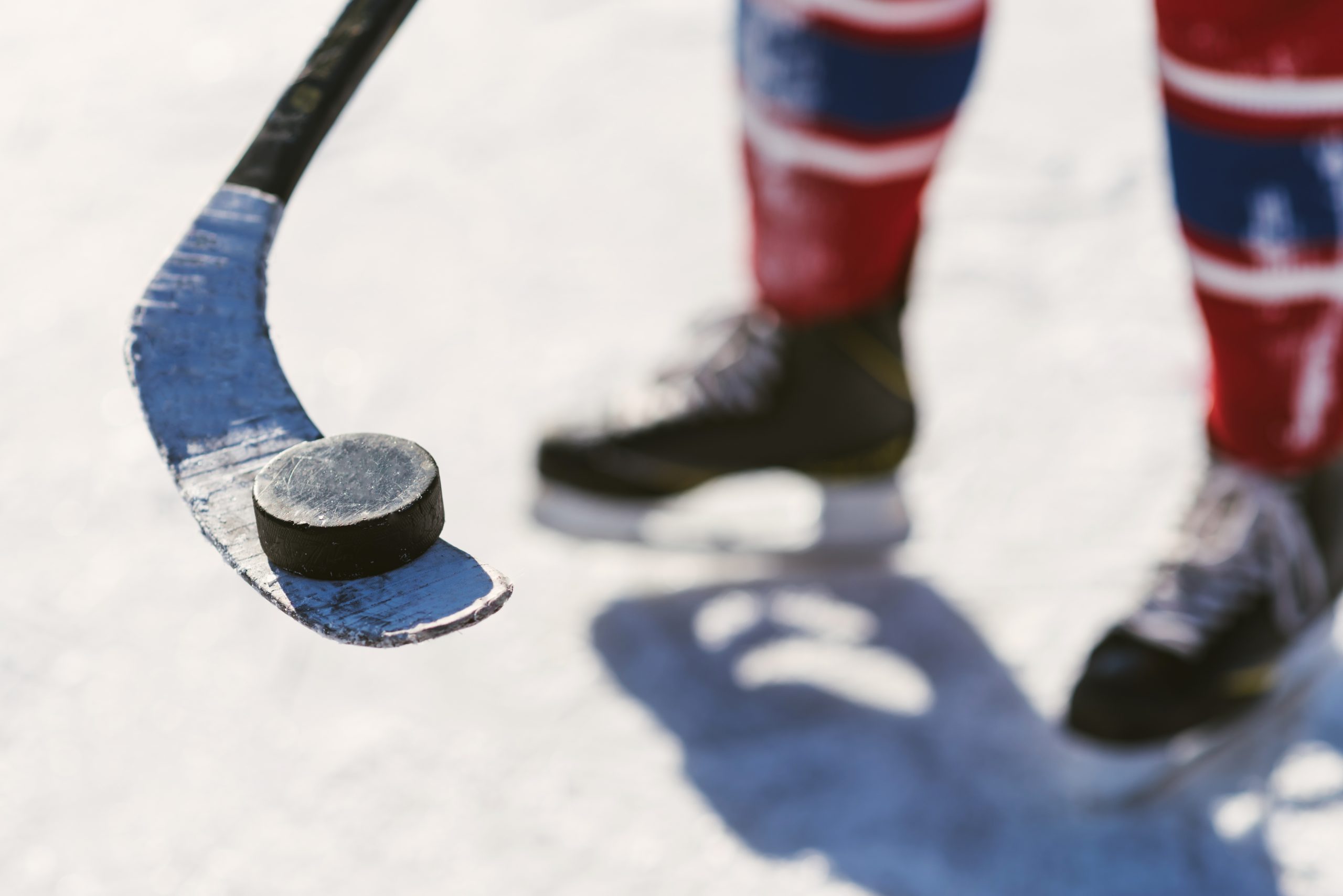 man holding a stick on the puck stadium